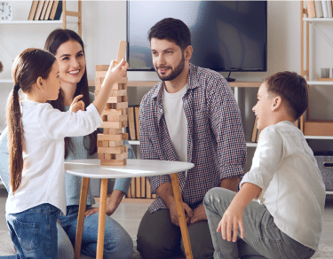 family playing jenga in the living room