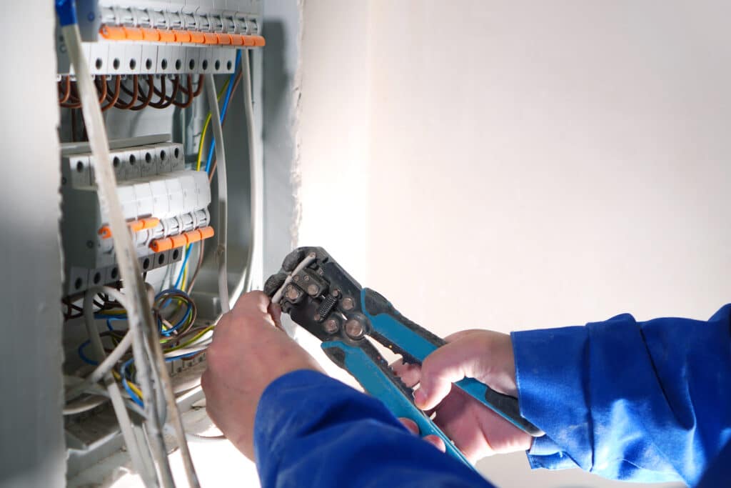 Electrician working on an electrical panel.