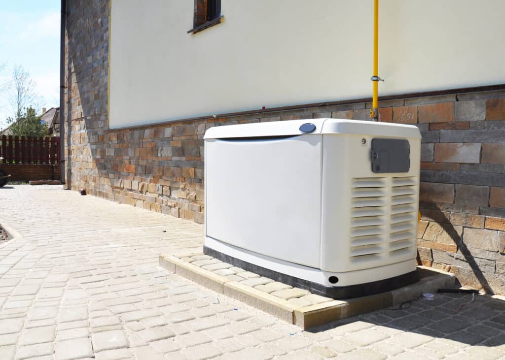 White whole-home generator next to a home in Johnson City.