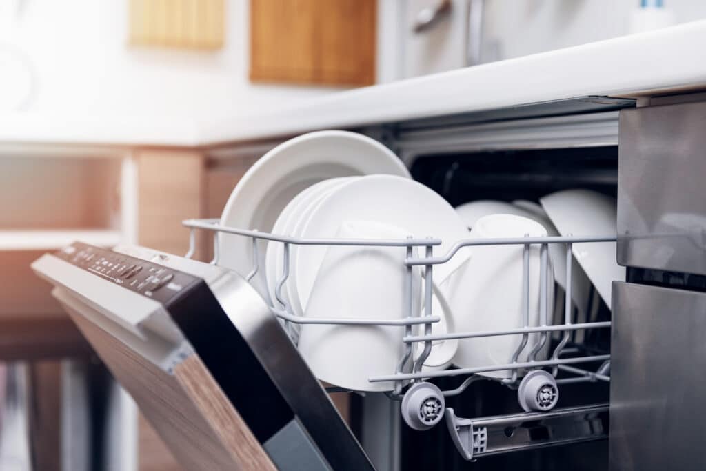 open dishwasher with clean dishes in a residential kitchen