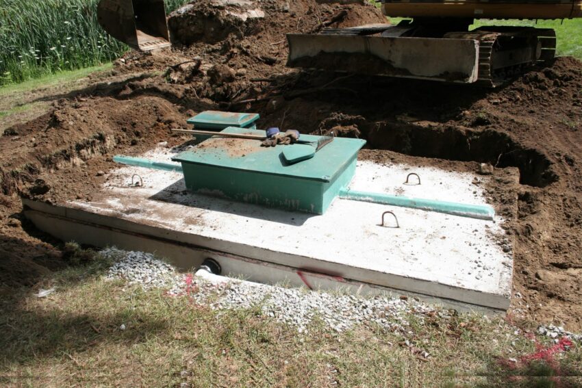 Septic system construction with concrete wastewater reservoir.